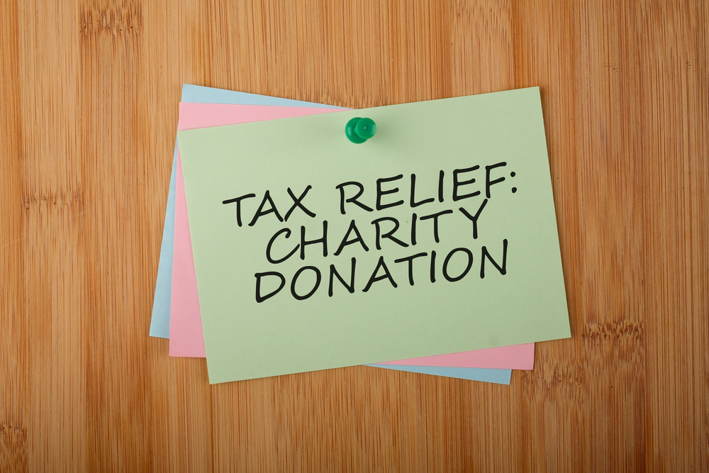 Tax Relief Charity Donation Written on Green Paper Note